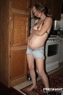 pregnant babe black-bra strips-off