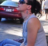Gorgeous brunette in sunglasses smokes a long white 120 cigarette outside