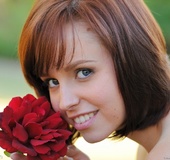 Petite tattooed redhead with blue eyes plays in the garden fully nude