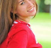 Pierced and tattooed little red riding good plays with her red toy outside