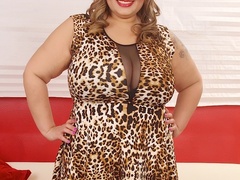 Tattooed brunette in leopard spot dress and black - Picture 1