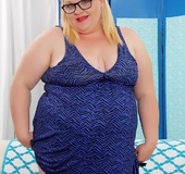Chubby blonde in glasses and blue dress fucks red dildo and white vibrator
