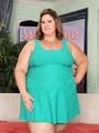 Hot plump brunette in short green dress - Picture 1