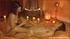 Lusty ebony lays down naked on a white matress by the pool and lets a