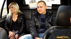 Blonde hottie rides on a fake taxi wearing her black leather jacket, shirt and jeans skirt then shows the driver her big tits before she sucks his cuck then lets him fuck her in different styles til he blasts in her mouth. - Picture 1