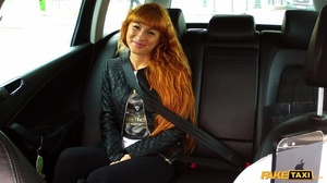 Cute redhead wearing black leather jacket lifts up her white shirt and gray bra and shows the driver her hot boobs then takes off her black pants and rubs her twat before she lets him bang her in different styles til her blows on her pussy in his fake taxi. - Picture 3