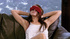 Steaming hot chick sits on a gray couch blindfolded and displays her smoking
