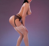 Alluring babe with stimulating body pose topless and reveals her indulging