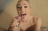 Busty lady covers her friend's dick in oil before masturbating it.