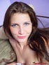 Blue eyed brunette masturbates and plays with a dick in bed.
