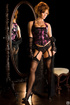 Tempting brunette in black and pink lingerie shows shapely ass and tits