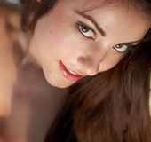 Sexy smiling brunette spreads her awesome long legs