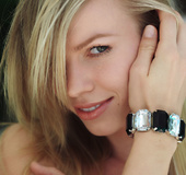 Smiling young blonde is getting naked in a truly passionate way