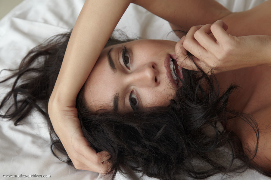 Curly-haired brunette is relaxing in the be - XXX Dessert - Picture 15