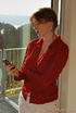 Spicy hot redhead MILF in white skirt, red shirt and black boots flaunts