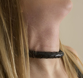 Kinky chick in leather rubs a whip against her crotch.