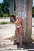 Brunette in lingerie is bound to a pillar and spreads her lips.