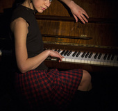 Girl shows off her body after a piano session.