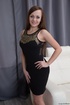 Girl in black dress gets her pussy wet on the couch.