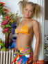 Sweet blonde in pigtails takes off her orange bra and reveals her sweet