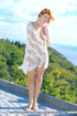 orange-haired babe poses beach