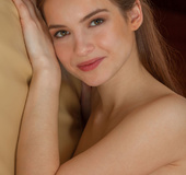 Sweet brunette teen gets totally naked on her yellow couch.