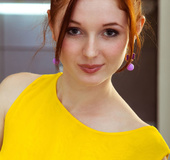 Redhead babe takes her canary dress off kitchen top to expose vag!