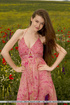 Sweet brunette babe takes her pink dress on a beautiful flower bed.