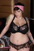 Lovely busty babe in pink head wrap and dark top and lingerie shows big