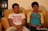 Asian studs in white shirt and gray pants and in yellow and blue shirt