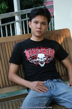 Handsome Asian guy sits on a wooden couc - XXX Dessert - Picture 1