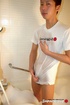 Japanese hottie in white shirt shows his dick on a brown bed before he