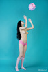 Brunette poses in tight pink panties and with volleyball ball