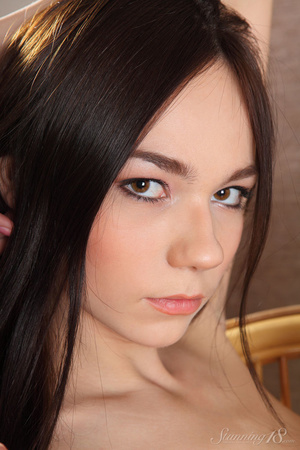 Skinny brunette girl with nice eyes sits - Picture 16