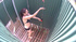 Busty ponytailed babe in black bikini taking shower