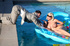 Big chested blonde in sunglasses and black bodysuit sunbathing in the