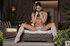 Exotic brown haired beauty poses next to fire place in leg warmers