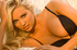 Blonde in sexy black lingerie and stockings shows off her luscious natural