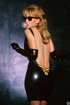 Naughty bitch in black latex pose for the camera on a longe chair