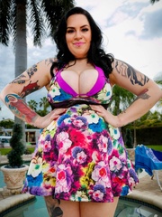 Tattooed fat chick takes off her multi colored dress - Picture 1
