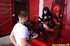 Tattooed Domme does dirty things to a young man in her dungeon.