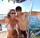 Busty cougar in a barely there bikini gets the bone on a launched boat.