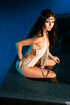 Brunette goddess with a gold ribbon a tattoo play in the pool