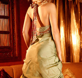 Tempting blonde wearing a green silky long dress embraces her inner bunny