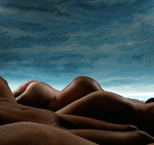 Erotic dark beauty smoking naked in bed showing her beautiful curves