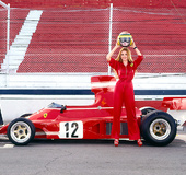 Buxom red-haired, blue-eyed racing slut with red Mustang will make anyone's