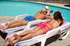 Two cute lesbian best friends with benefits pose at the pool