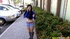 Long haired lass in jeans shorts and blue top sucking cock on her knees