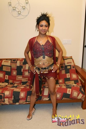 High heeled indian gal sheds her red outfit and exposing her tits and shaved snatch on the couch - XXXonXXX - Pic 1