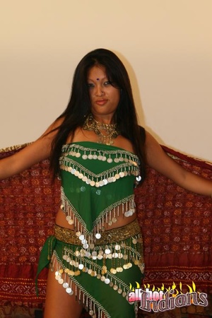 Grey eyed indian girl in green outfit undressing and exposing her black thongs and big juggs on the sofa - Picture 2